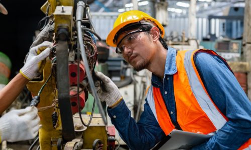 asian engineering worker man wearing uniform safety and hardhat working machine lathe metal in factory industrial, worker manufactory industry concept.