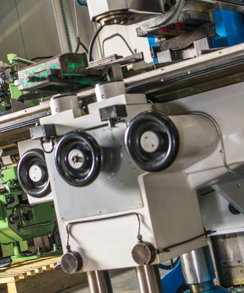 Heavy Duty Lathe Machinery Operator. Caucasian Metalworking Industry Worker in Front of the Machine.